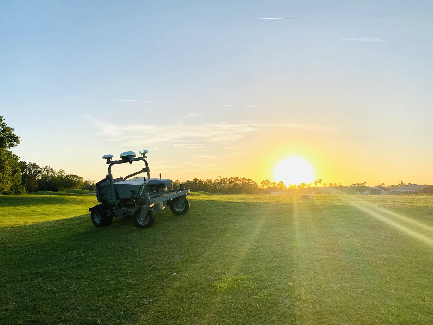 FJD RM21 on a golf course at sunrise